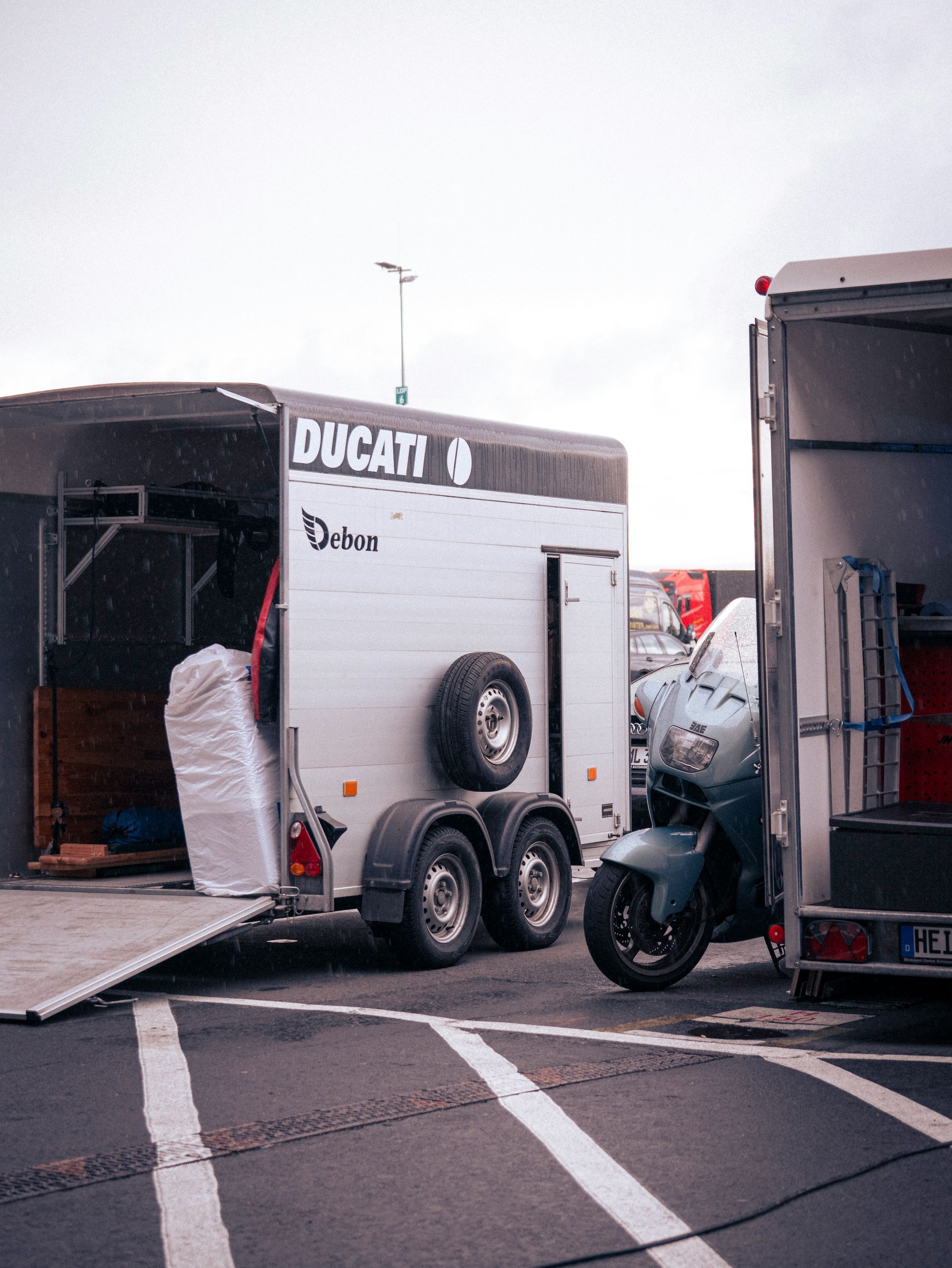 A ducati trailer with a motorcycle is parked.